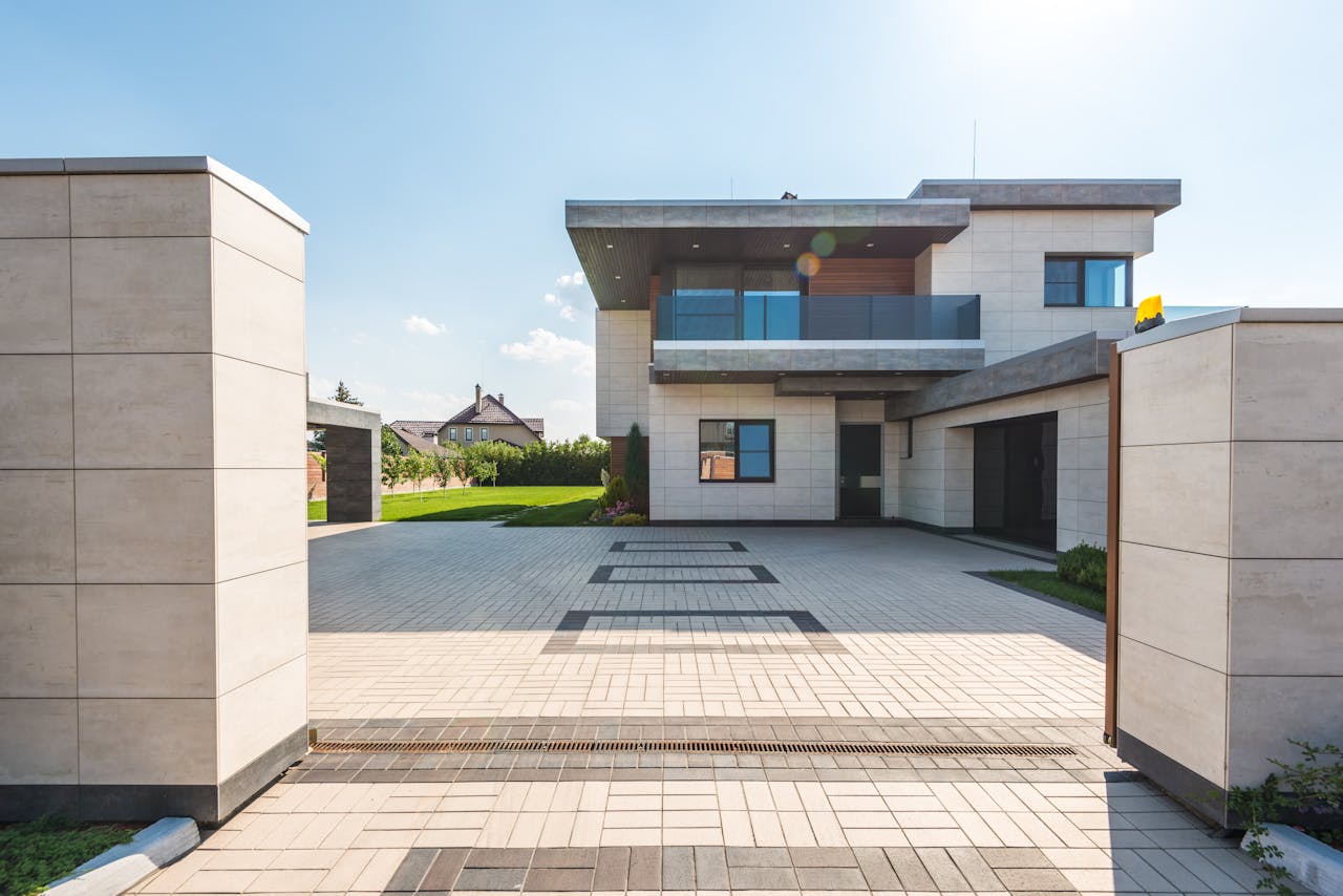 Home Contemporary two-story luxury home with spacious paved driveway and garden.